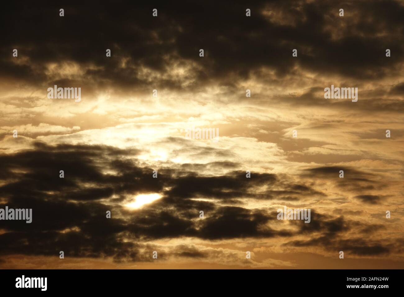 Sun shines through storm clouds hi-res stock photography and images - Alamy