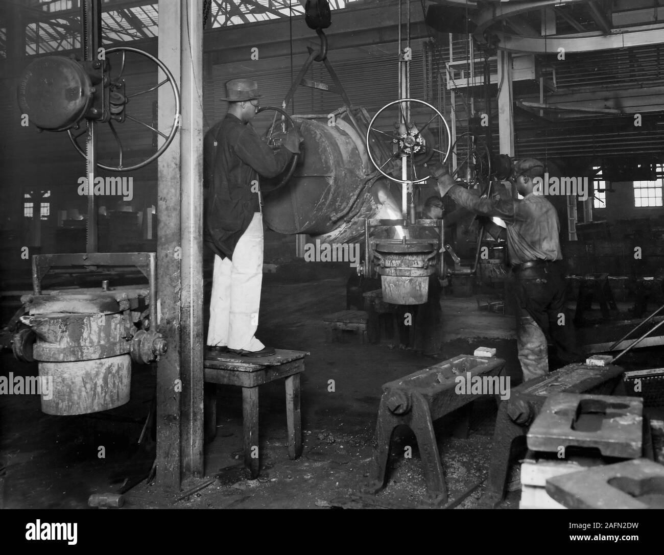 Workers are shown on the Allis Chalmers factory floor in Milwaukee, Wisconsin, ca. 1930. Stock Photo