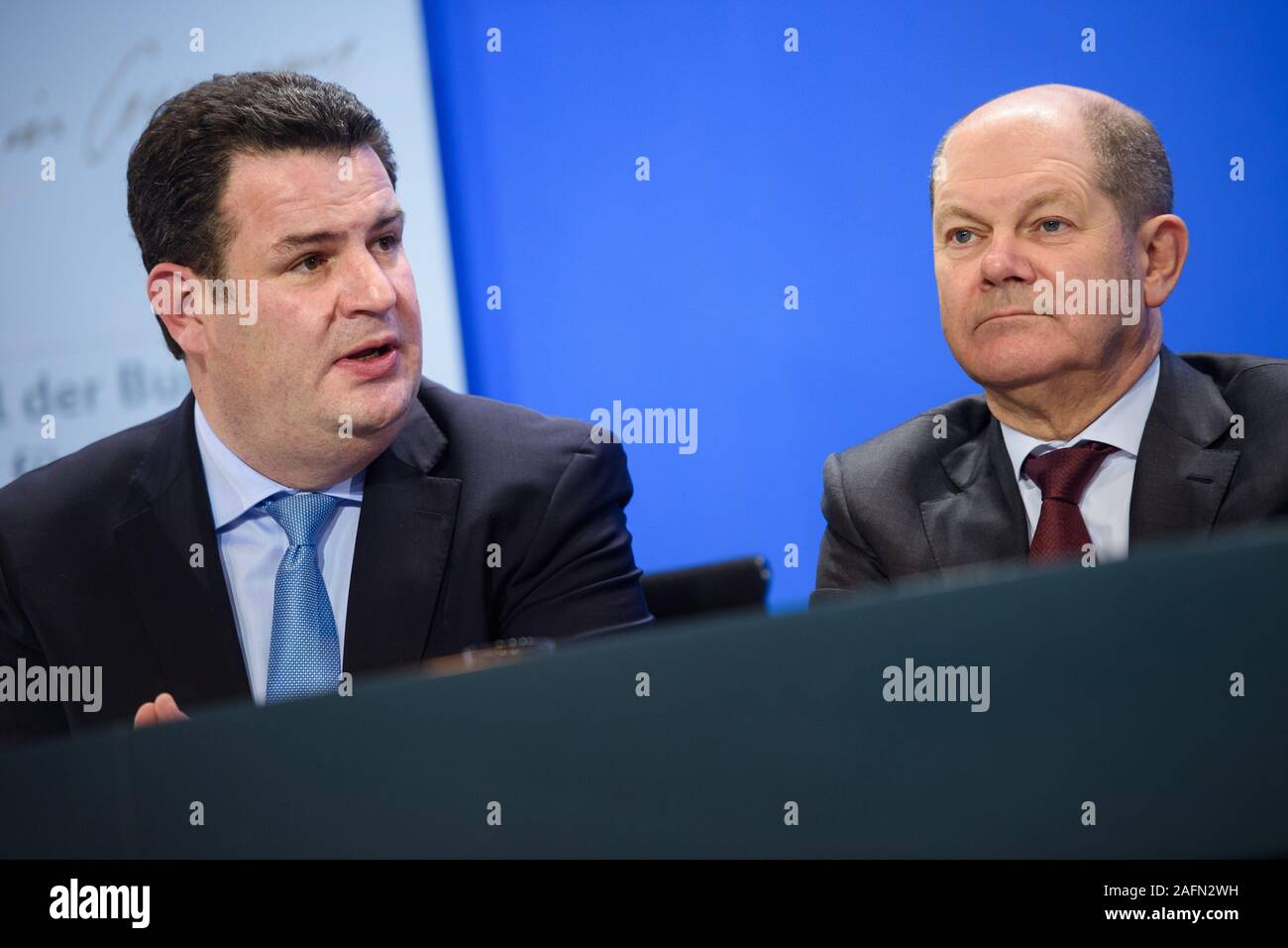 Berlin, Germany. 16th Dec, 2019. Hubertus Heil (SPD, l-r), Federal Minister of Labour and Social Affairs, and Olaf Scholz (SPD), Federal Minister of Finance, speak at a joint press conference with other government representatives at the Federal Chancellery after a summit to promote the recruitment of skilled labour from third countries. Credit: Gregor Fischer/dpa/Alamy Live News Stock Photo