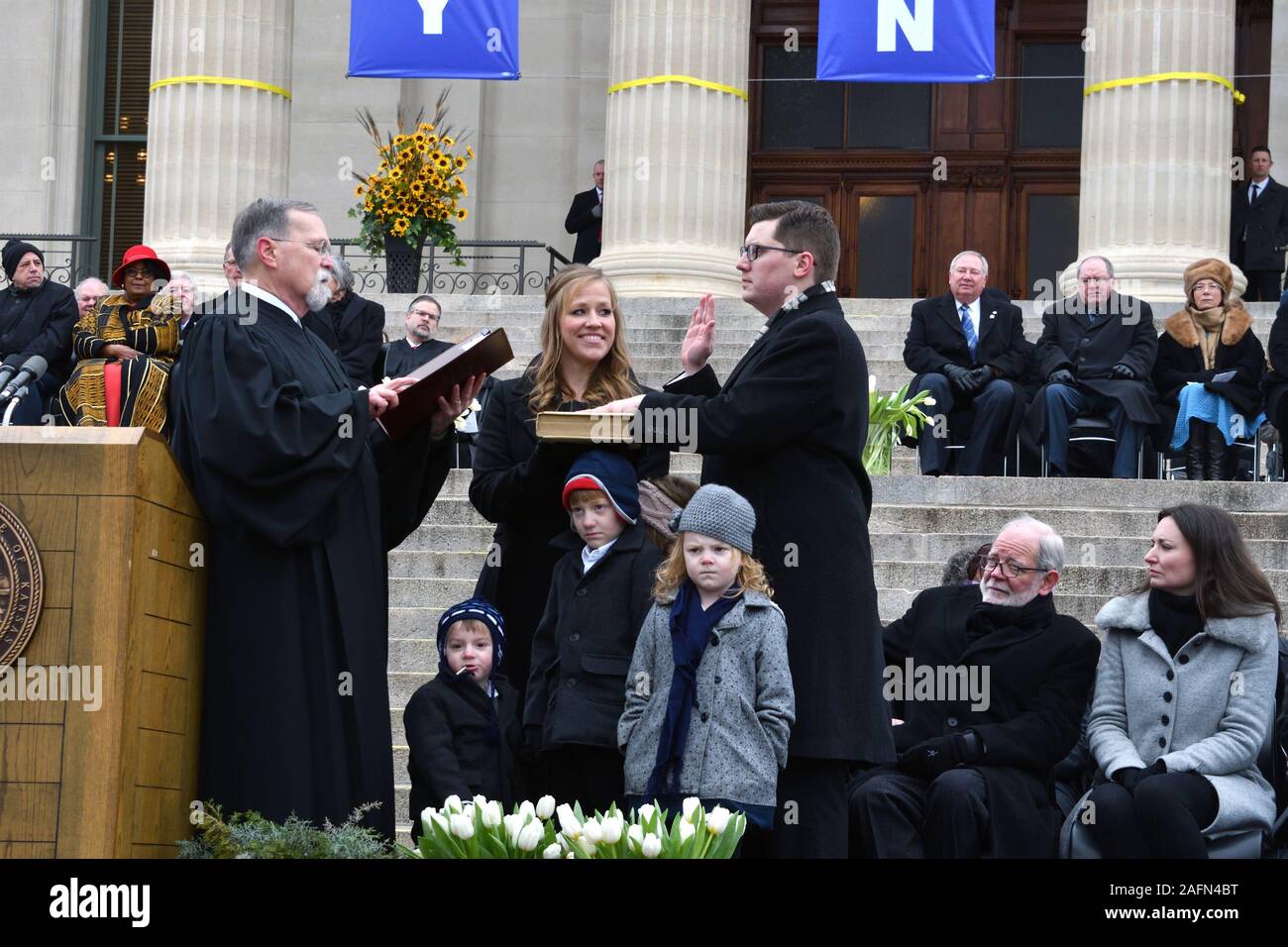 Topeka, Kansas, USA, January 14, 2019Democrat Governor Laura Kelly delivers her inaugural speech is front of the steps of the Kansas State Capitol buildingTopeka, Kansas, USA, January 14, 2019 Kansas State Treasurer Jake Laturner with his wife Suzanne holding the Bible as Chief Justice of the Kansas Supreme Court Lawton Nuss administers the oath of office while his children Ava, Joe, Maggie, and Gus stand and watch Credit: Mark Reinstein/MediaPunch Stock Photo