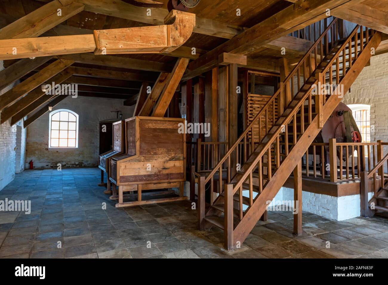 Inside view of wooden interior of old mill used as museum Stock Photo