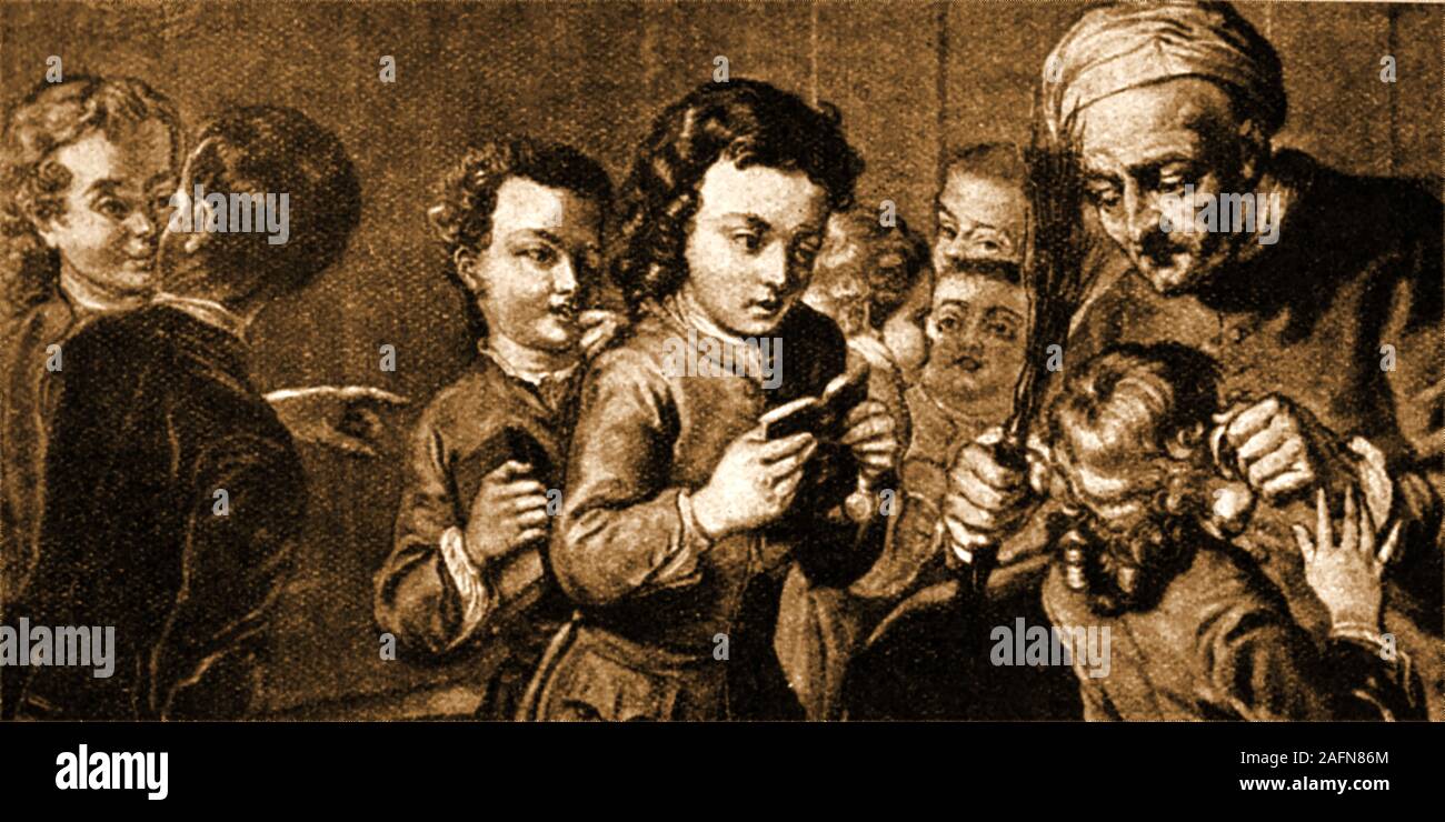 An 18th century  English school room scene showing a childbeing ill treated from his teacher who holds a birch twig (for punishment) , grabbing him by the ears his ears Stock Photo