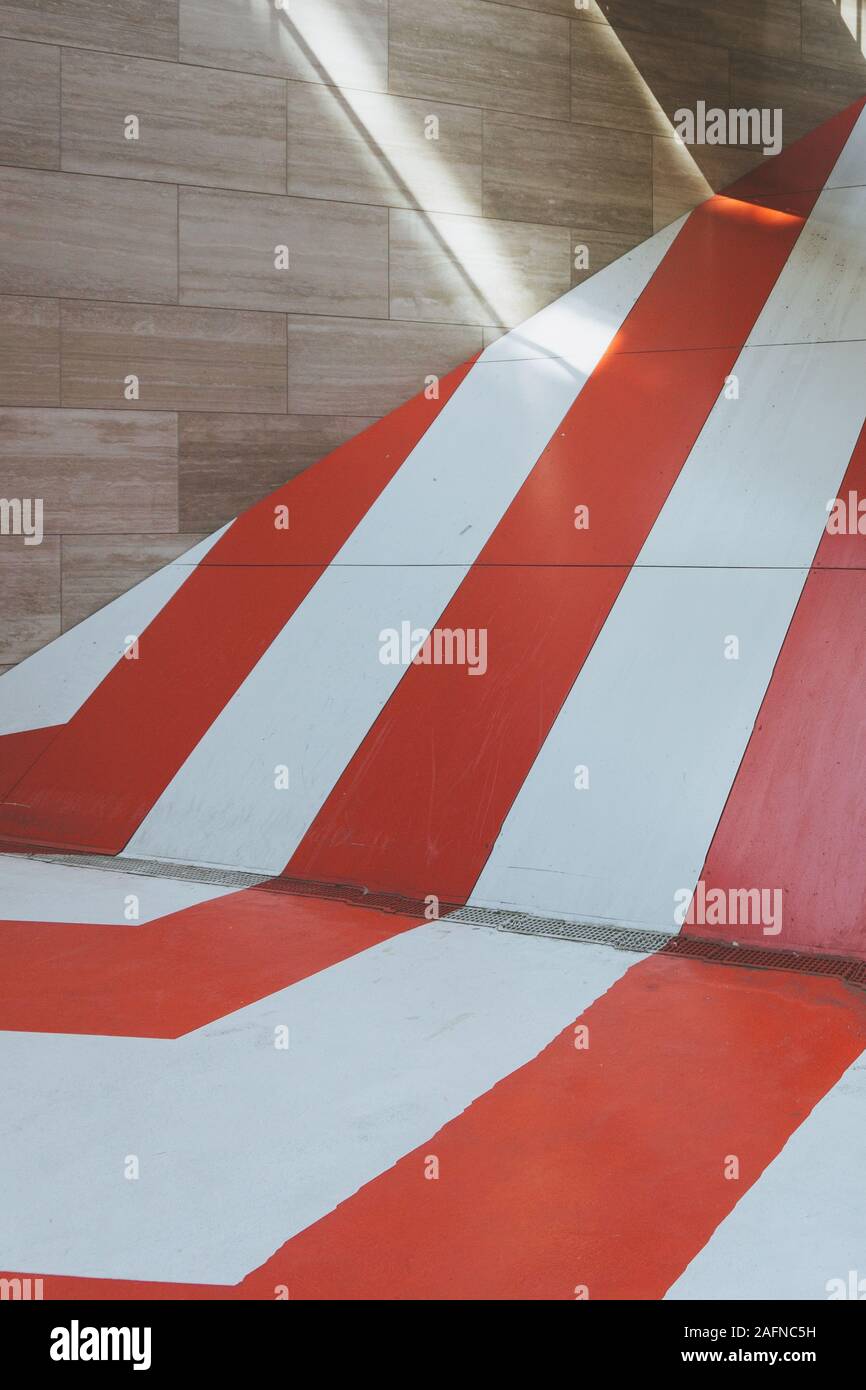 Vertical shot of a wooden wall with a ramp painted with white and red ...