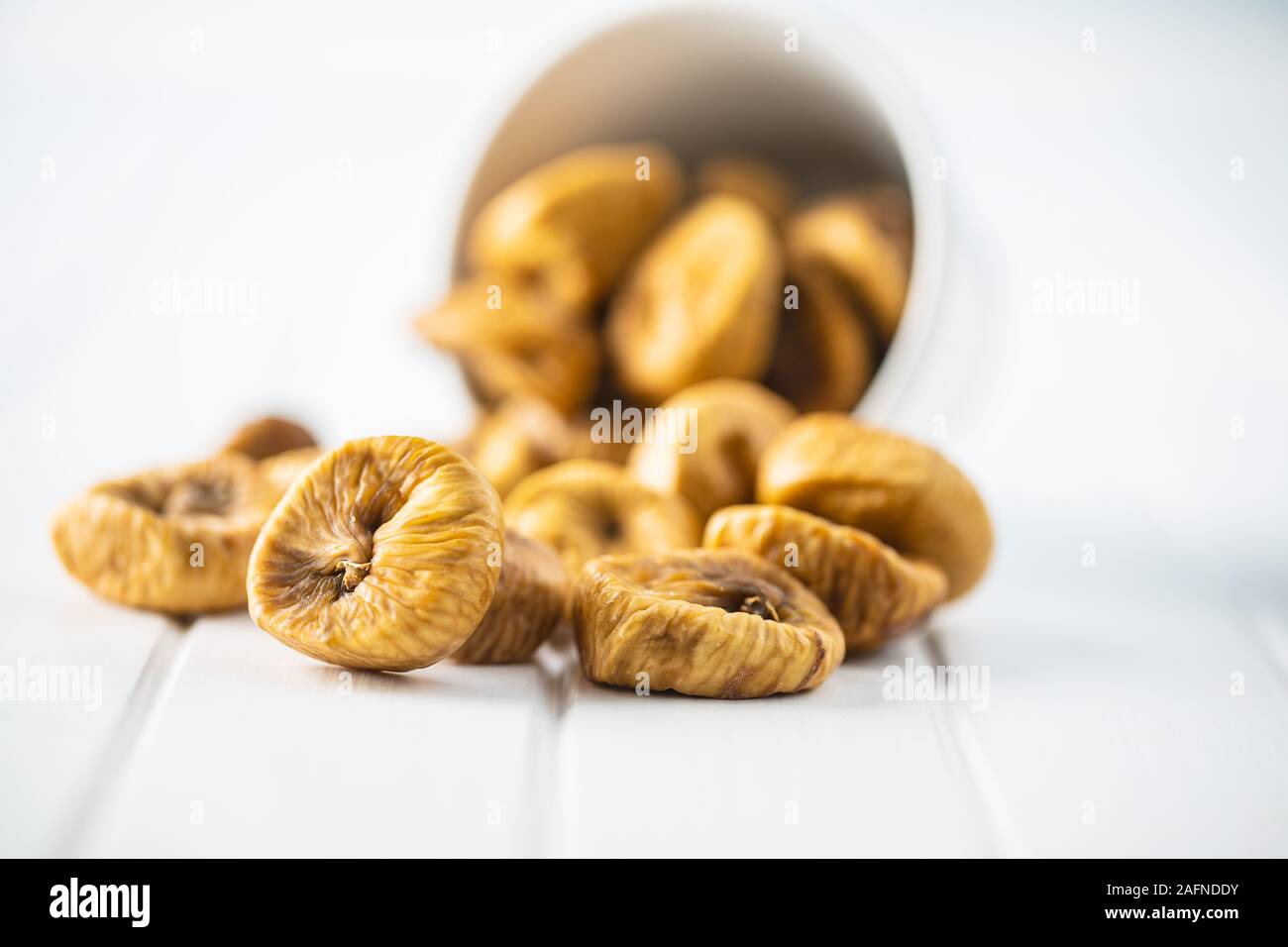 Sweet dried figs on white table. Stock Photo