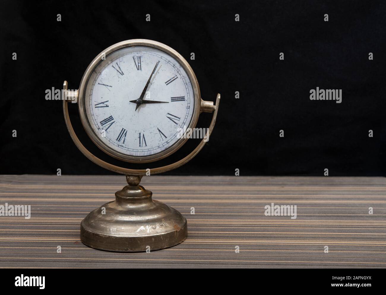 Vintage style alarm clock on black background banner with copy space