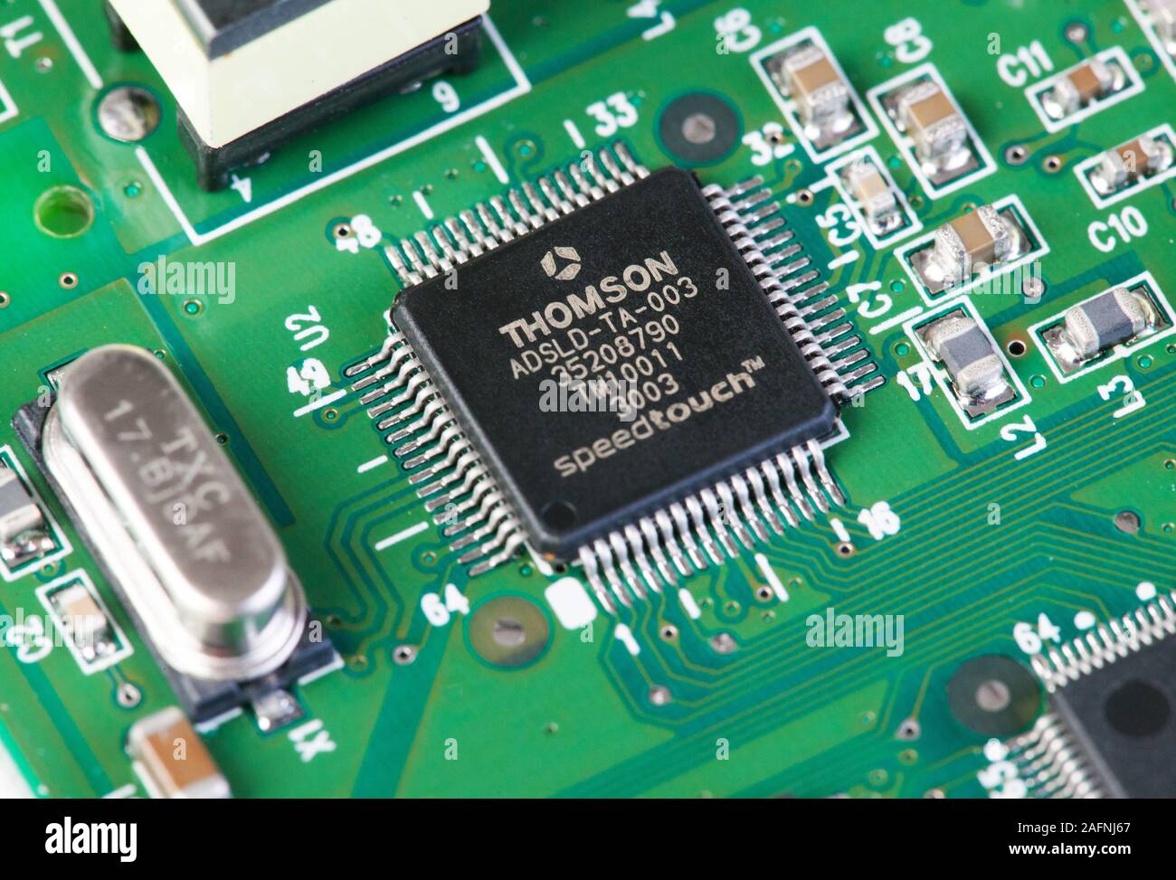 Thomson (STMicroelectronics) 64 pin QFN integrated circuit chip on surface mount circuit board Stock Photo