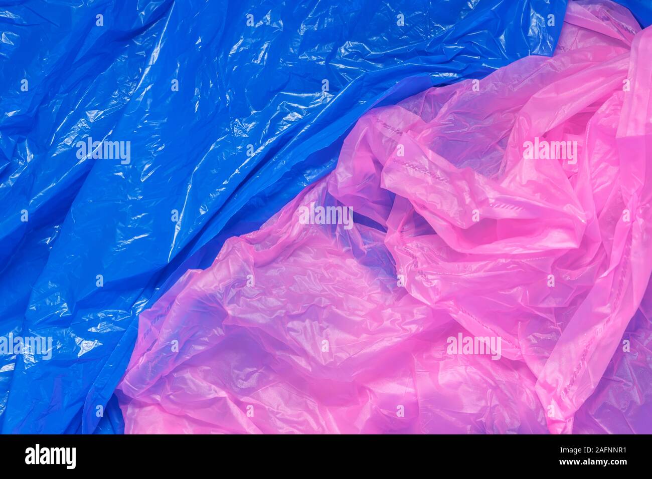 bright multicolored abstract background of used color polyethylene bags, environmental pollution concept Stock Photo