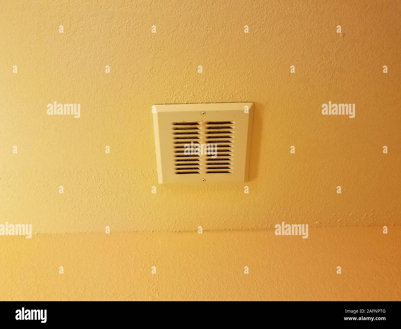 dirty metal bathroom vent or grate on orange or yellow ceiling Stock ...