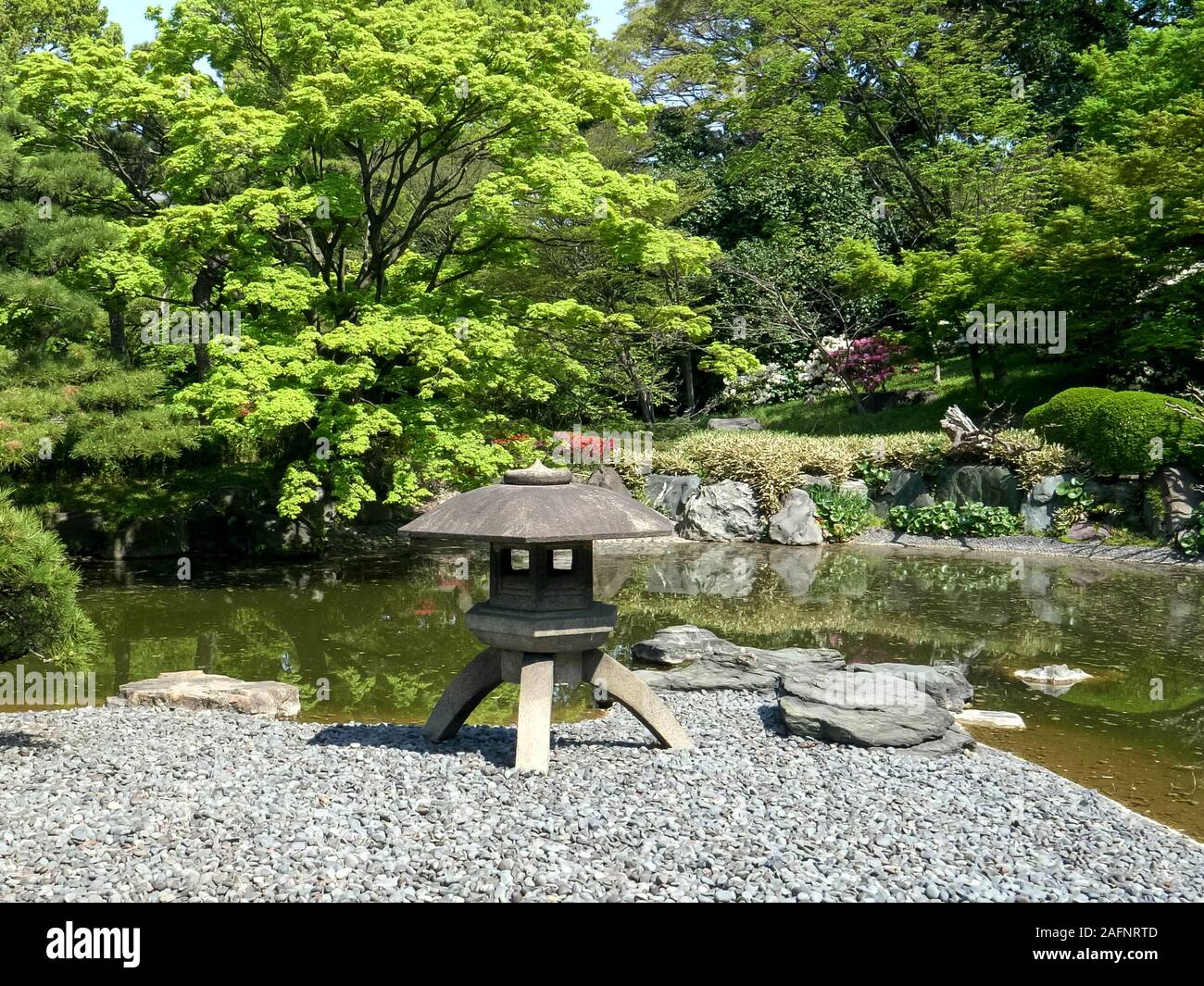 japanese stone lantern and koi pond at the imperial palace in tokyo Stock Photo