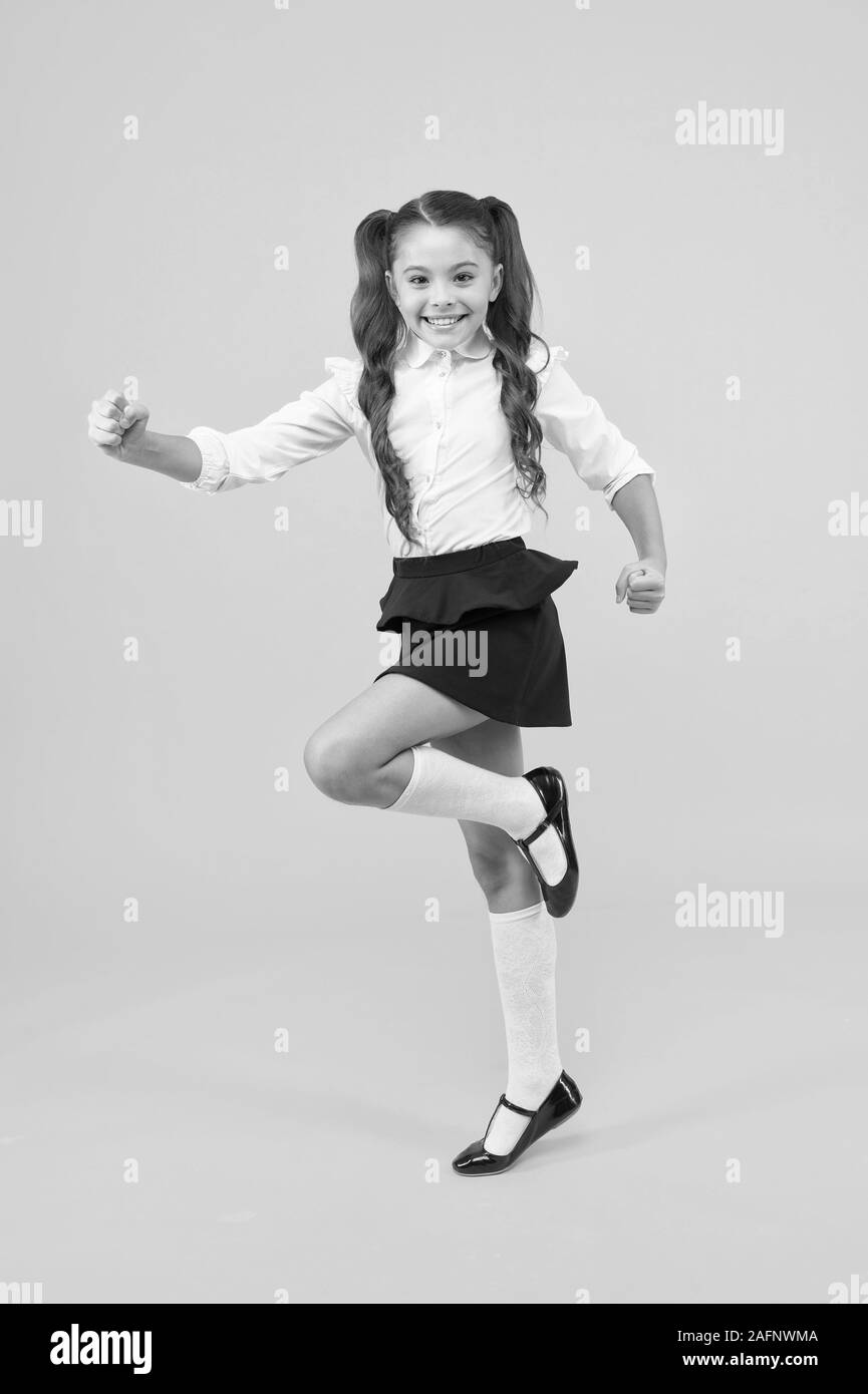 Keep going. Active kid. Girl on way knowledge. Knowledge day. Back to school. Kid cheerful schoolgirl running. Pupil want study. Active child in motion. Freedom concept. Knowledge determined success. Stock Photo