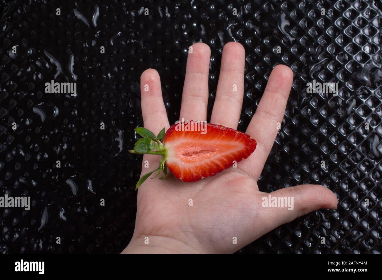 Juicy, sweet and ripe strawberry fruit in hand Stock Photo - Alamy