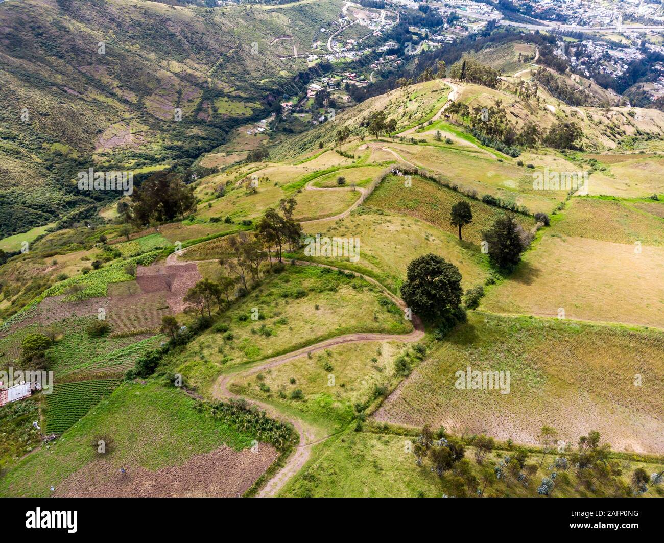 Hillsides of Mount Ilaló where there are cultivated fields, native forest and zigzagging paths Stock Photo