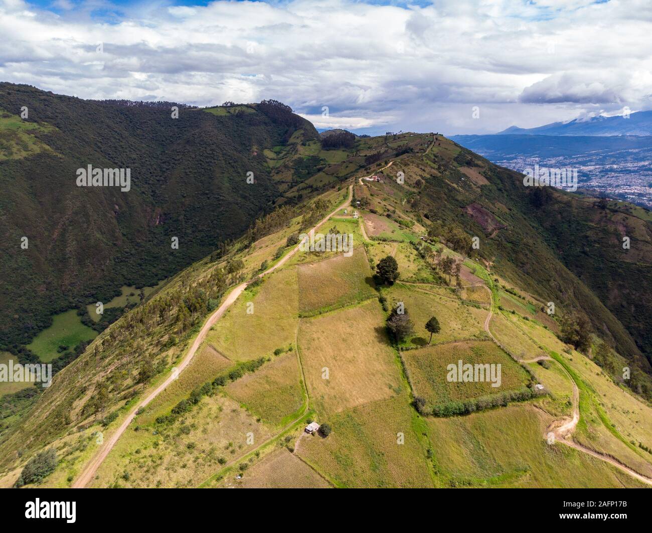 Hillsides of Mount Ilaló where there are cultivated fields, native forest and zigzagging paths Stock Photo
