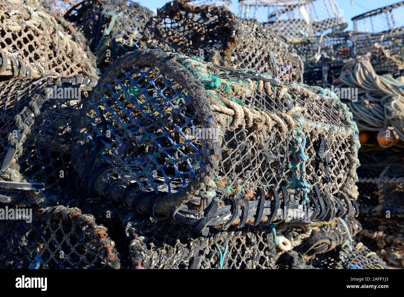 Large piles of creels or pots used by inshore fishers to catch crabs and lobster on the quayside at Paignton, Devon, UK. Stock Photo