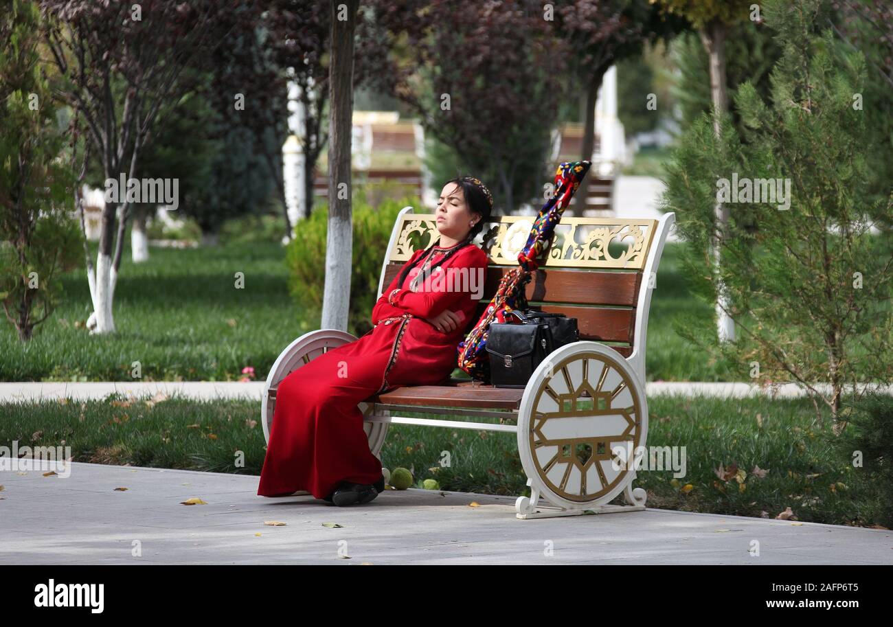 Young student resting on a park bench in Ashgabat Stock Photo