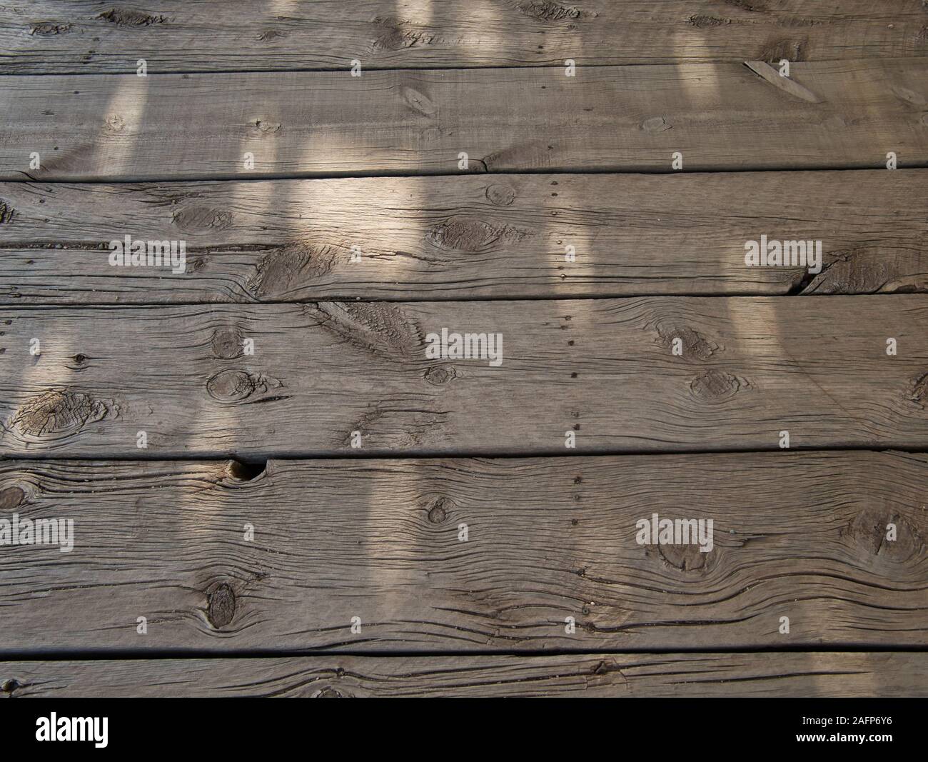 Untreated and weathered wooden beams on a very old veranda Stock Photo
