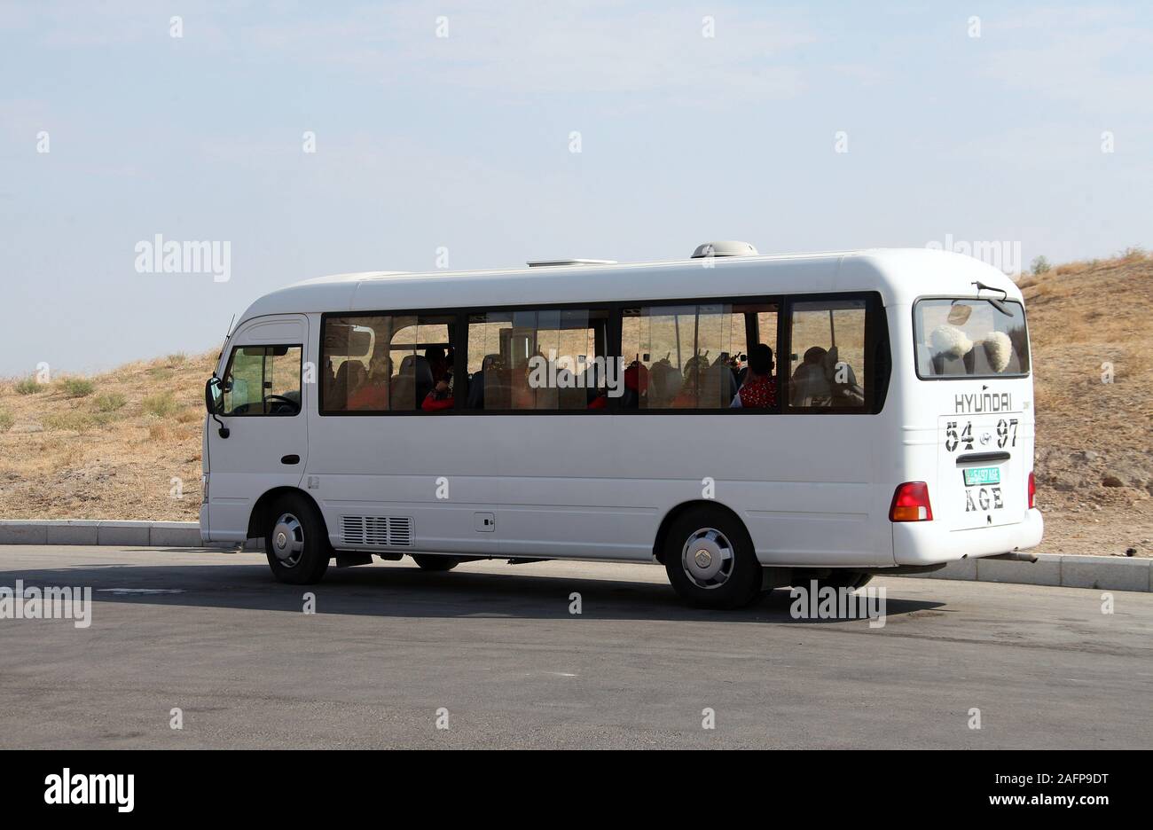 Bus full of people wearing traditional costumes in Turkmenistan Stock Photo