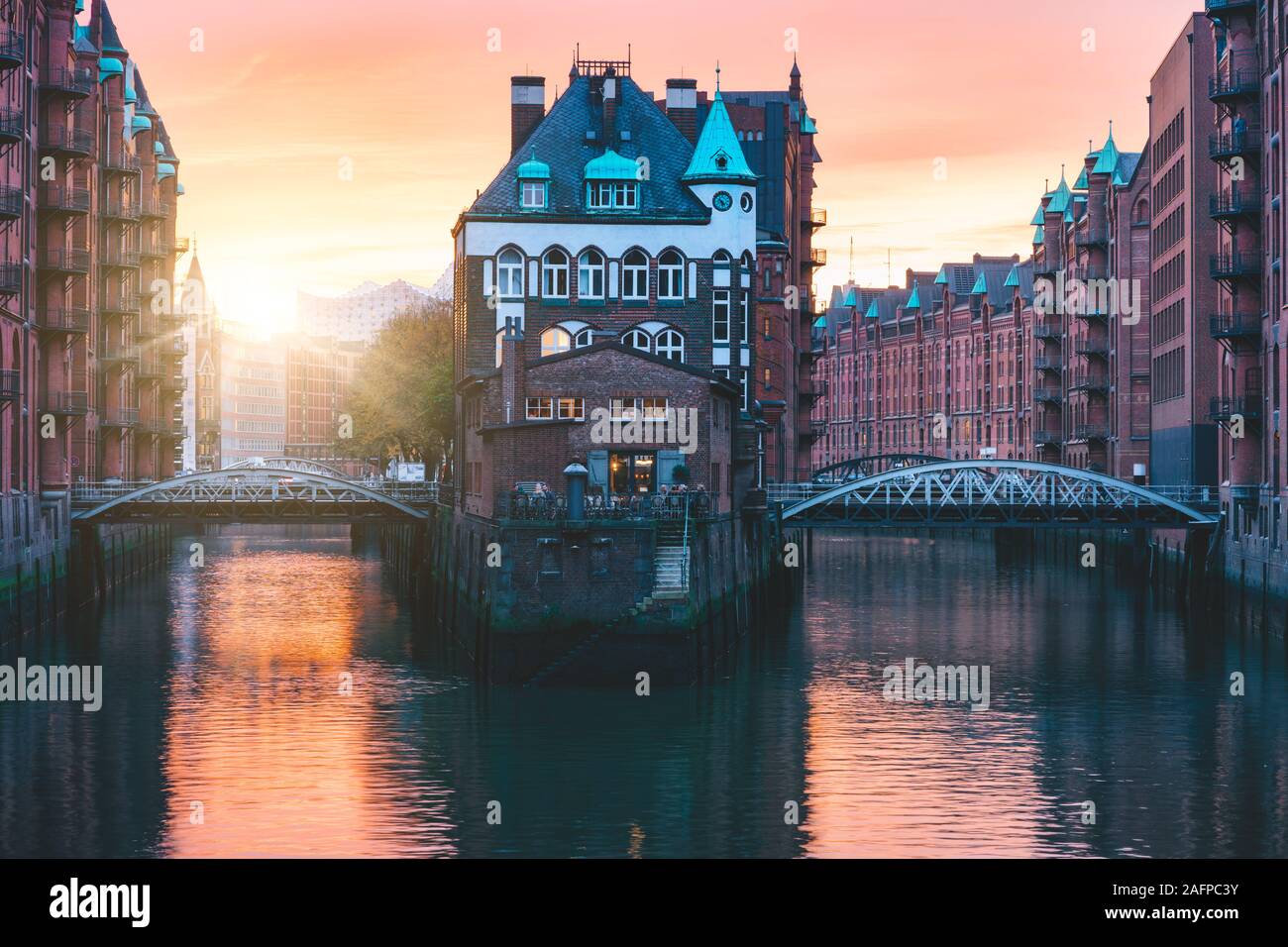 Hamburg city old port, Germany, Europe. Historical famous warehouse district with water castle palace at sunset golden light Stock Photo
