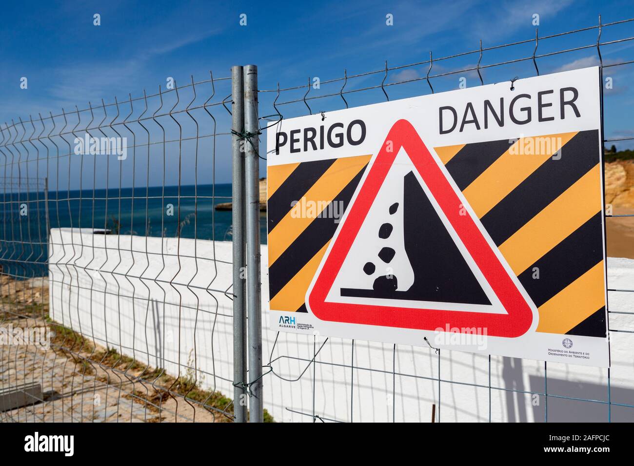 Sign warning of danger cliff fall, Algarve, Portugal Stock Photo