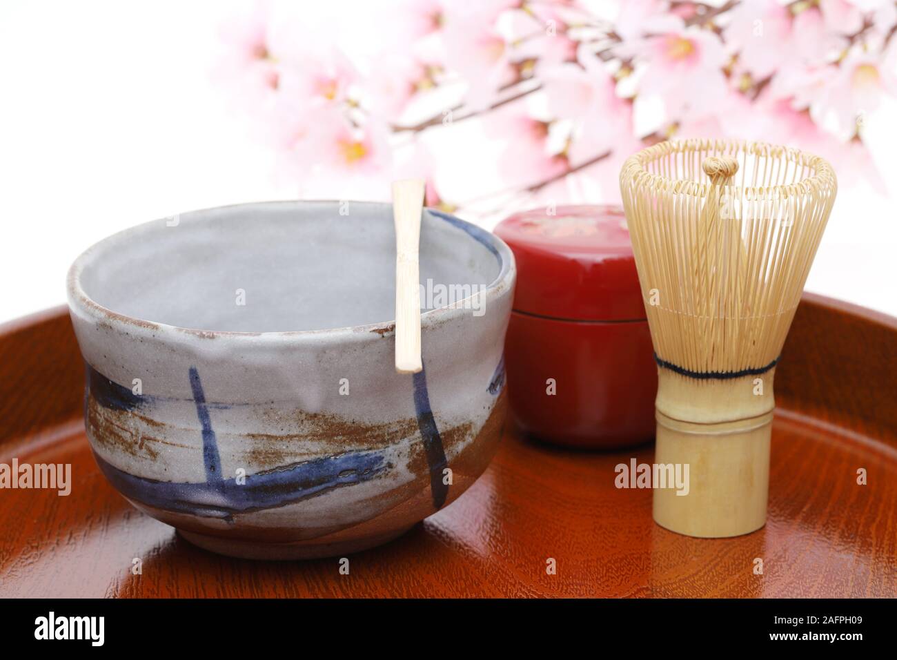 Tea bowl with tea whisk and bamboo spoon used in Japanese matcha green tea ceremony Stock Photo