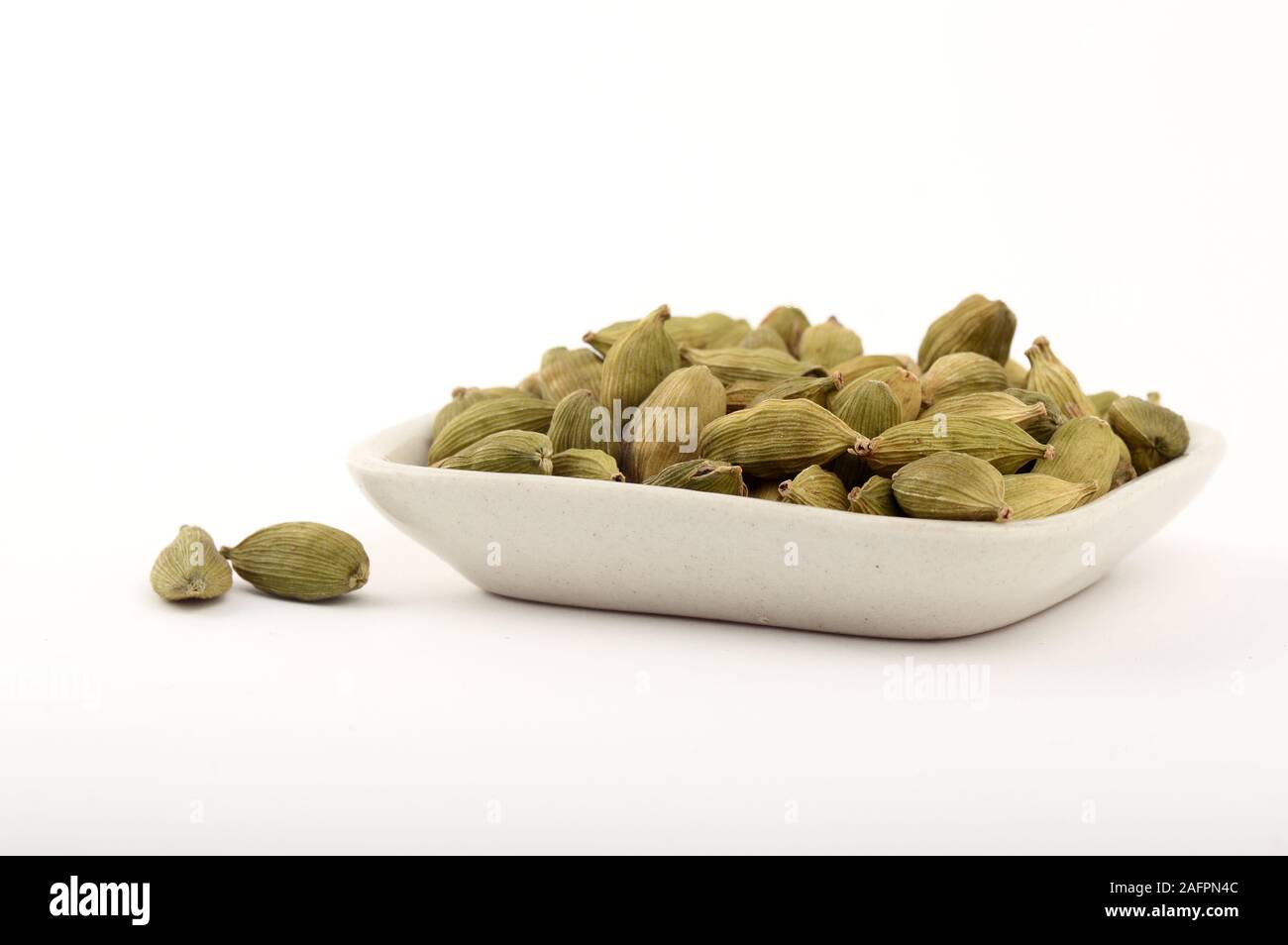 Green Cardamom pods in plate Stock Photo Alamy