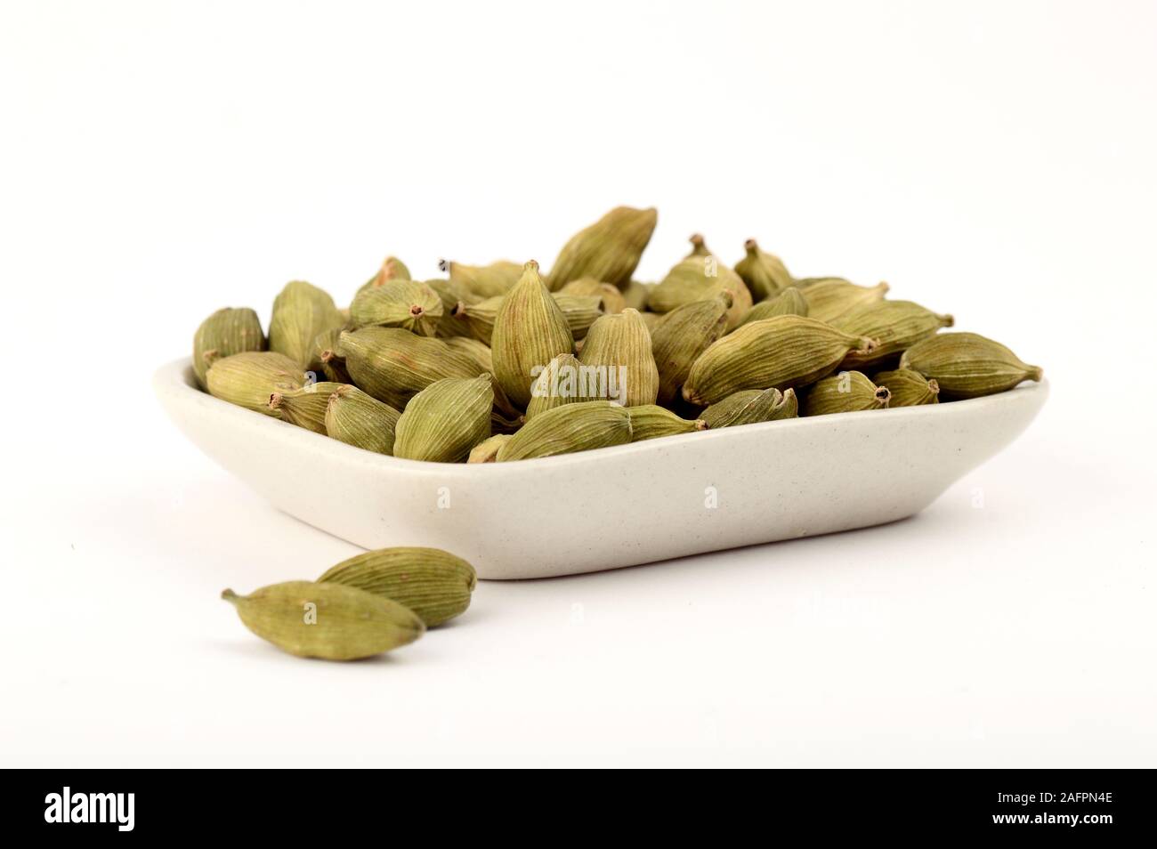 Green Cardamom pods in plate Stock Photo Alamy