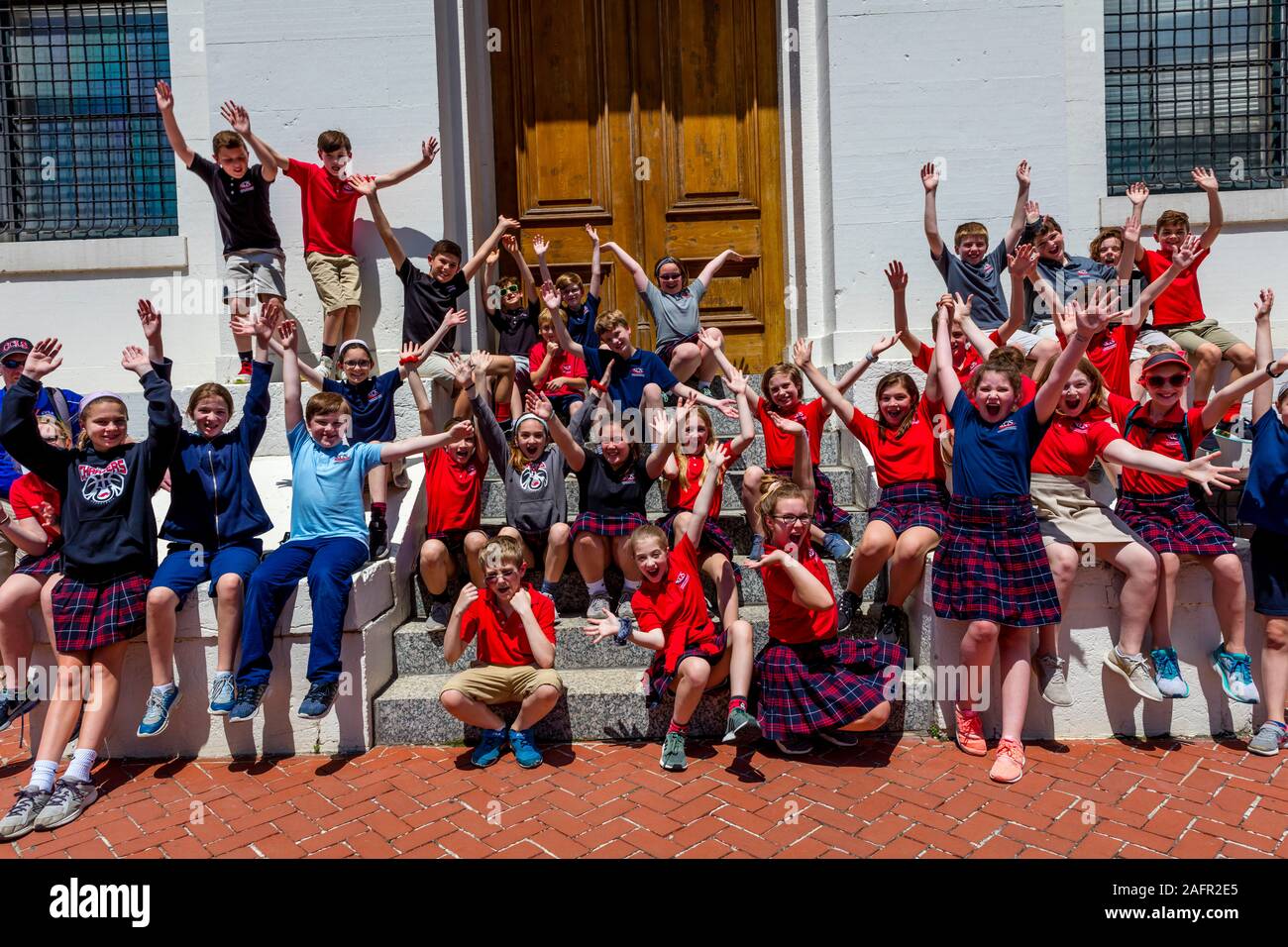 MAY 16, 2019 ST LOUIS, MO. USA - School kids raise hands and smile in front of Old Court House, St. Louis, MO Stock Photo