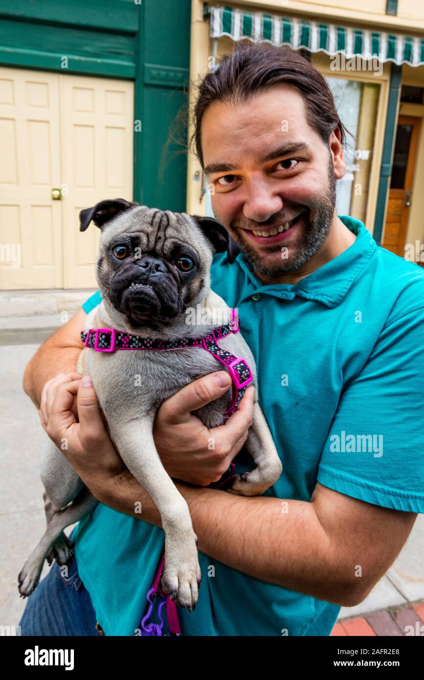 MAY 18 2019, USA - Man and pug dog Stock Photo