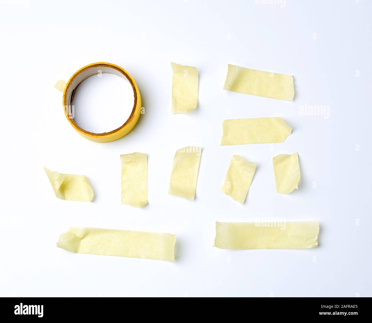 set of various pieces of yellow sticky paper tape on a white background, close up Stock Photo