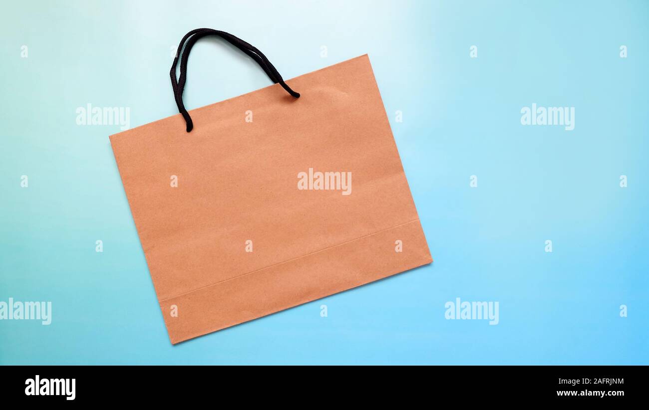 A flat brown paper bag on a blue background Stock Photo - Alamy