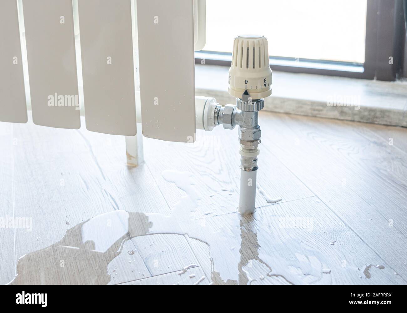 water leak through the heating radiator tube nut Stock Photo Alamy