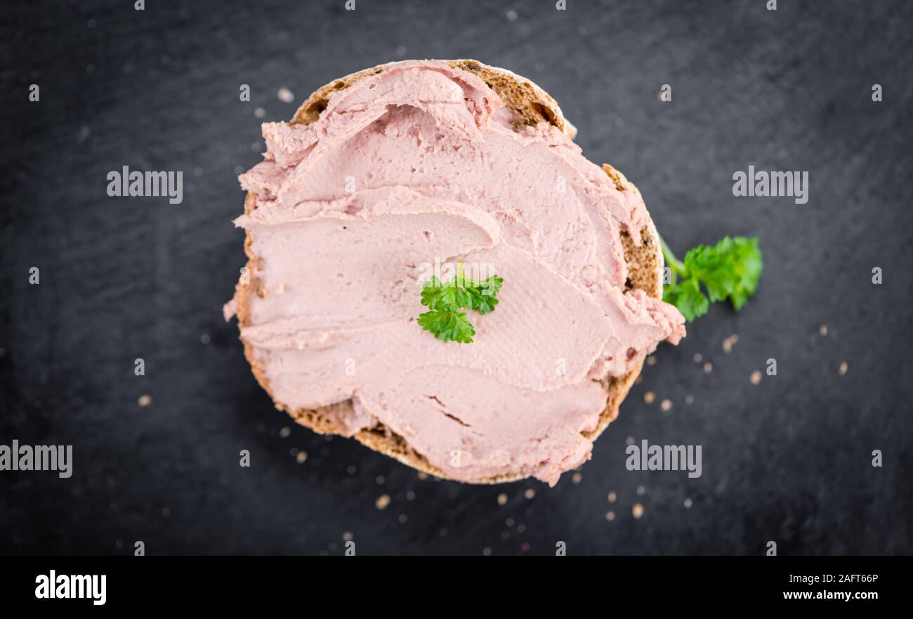 Roll with Liverwurst (German cuisine) on a vintage slate slab (closeup