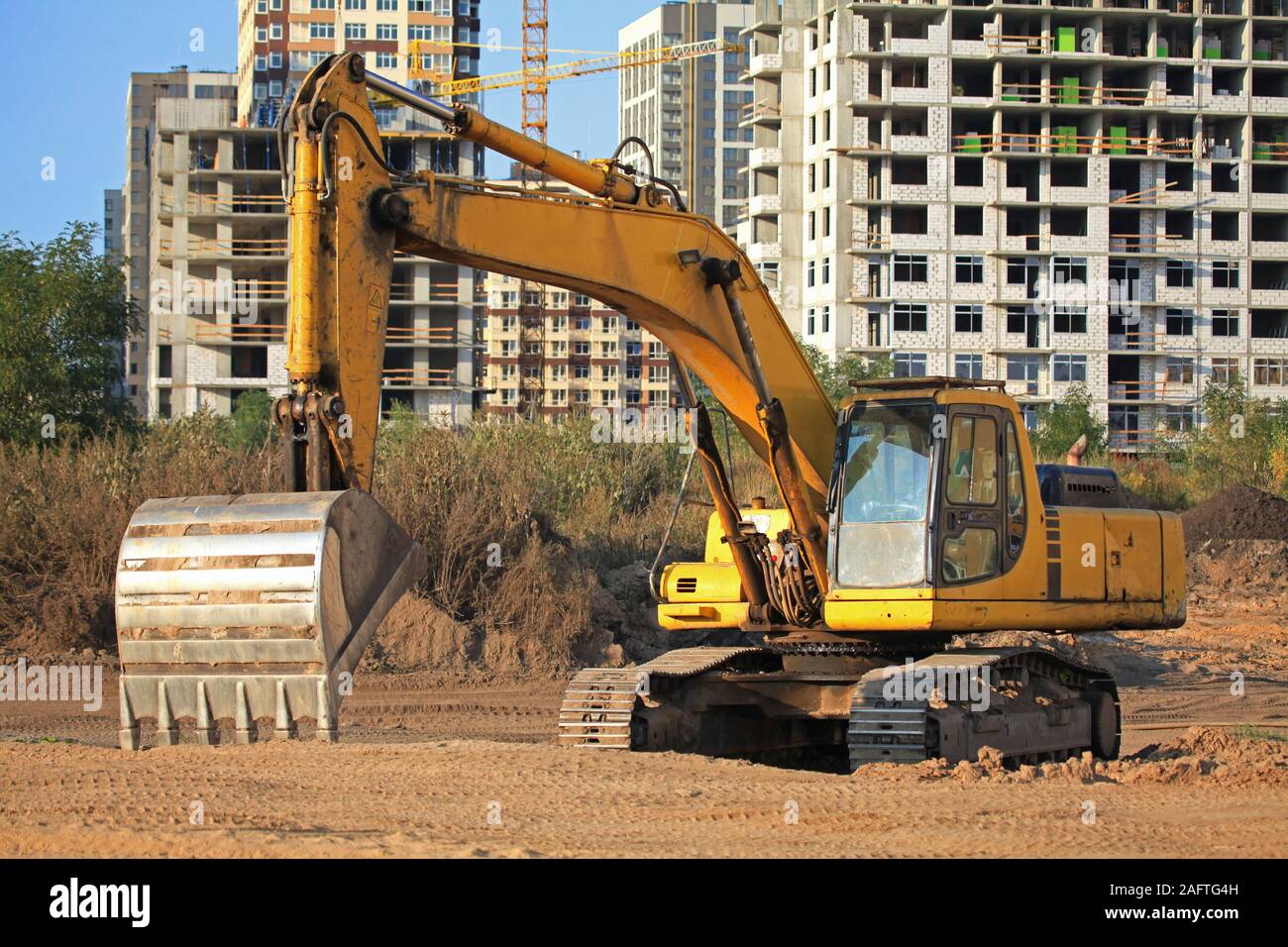 Excavator (digger) with a huge bucket at a construction site. Construction machinery at the