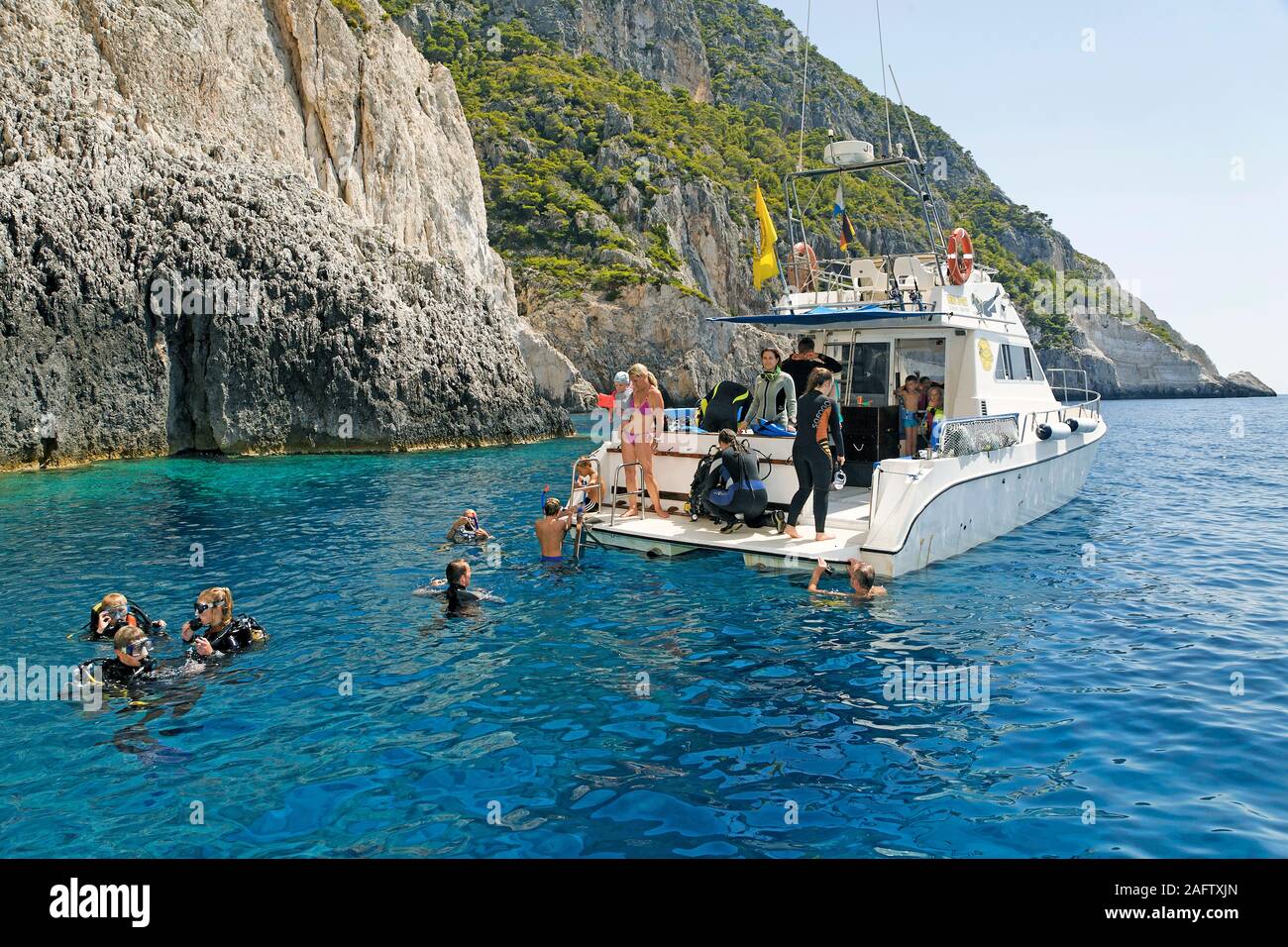 Scuba diver in water at the diving boat, Zakynthos island, Greece Stock Photo