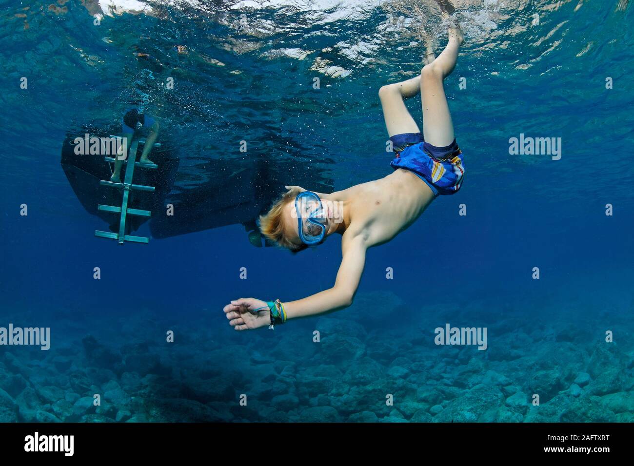Child playful in warm Mediterranean sea, diving, Zakynthos island, Greece Stock Photo