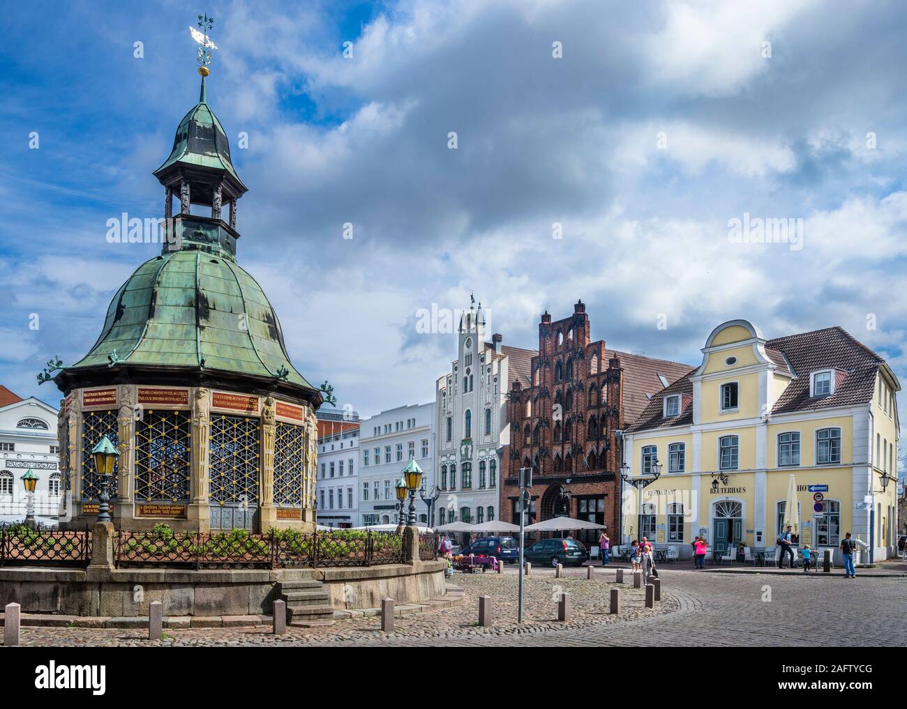 Wasserkunst at the Wismar market square, the historic ornate structure on the site of a 16th-century water fountain is a spring-fed stone well built t Stock Photo