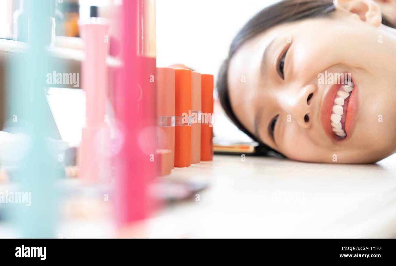 Asian woman deciding to choose lipstick Stock Photo