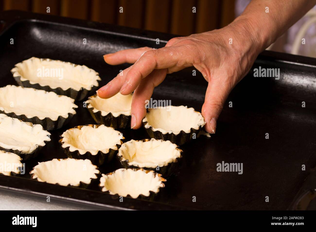 raw tartlets on oven sheet. close up Stock Photo