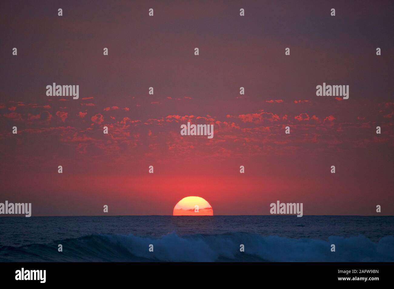 Sunset in red sky over ocean horizon, Punta de Mita, Nayarit, Mexico Stock Photo