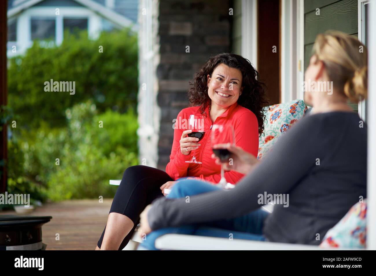 Women sitting on a porch hi-res stock photography and images - Alamy