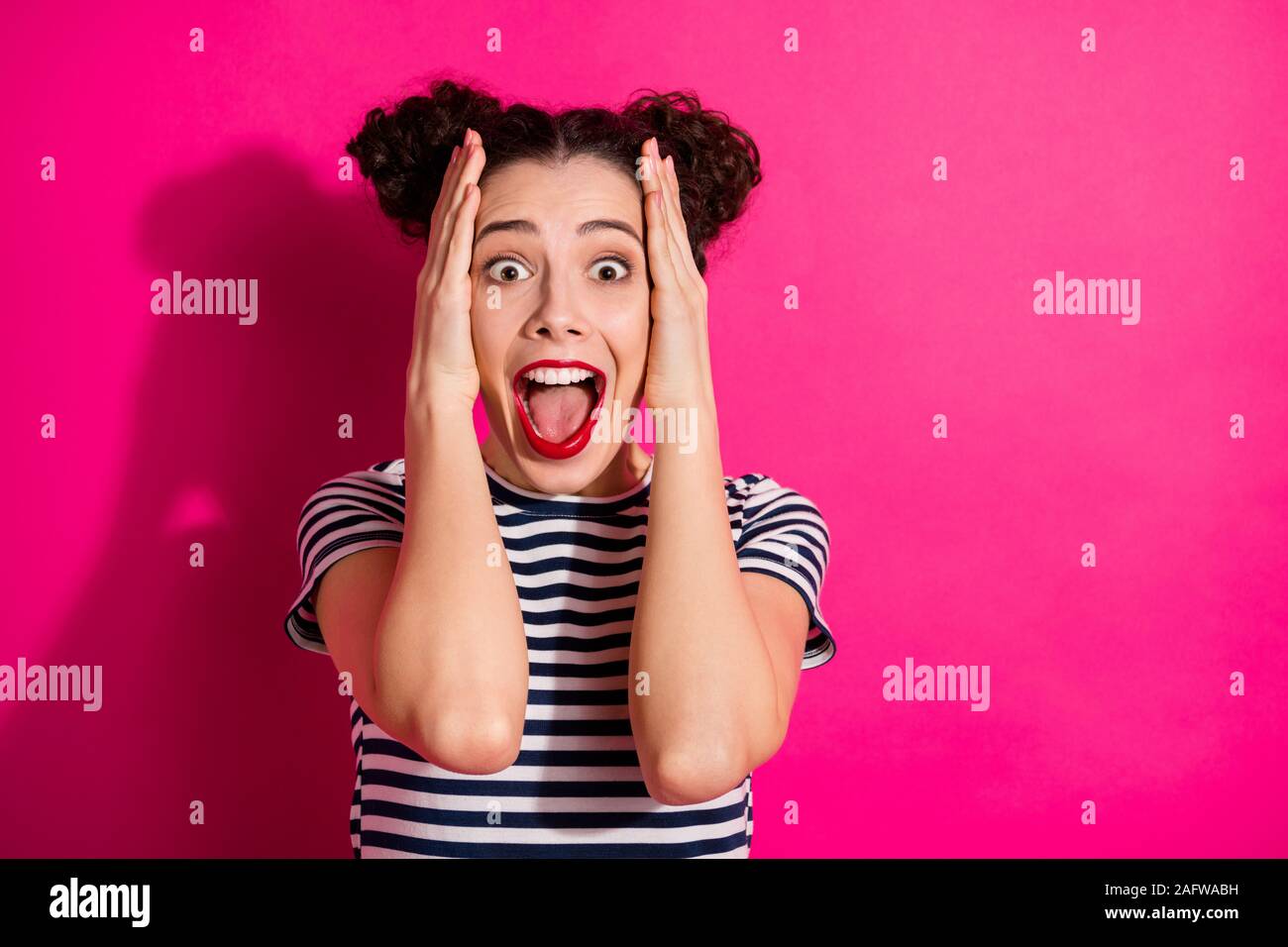 Photo of cheerful cute nice charming attractive girlfriend screaming shouting crazily wearing striped t-shirt isoalted over fuchsia vivid color Stock Photo