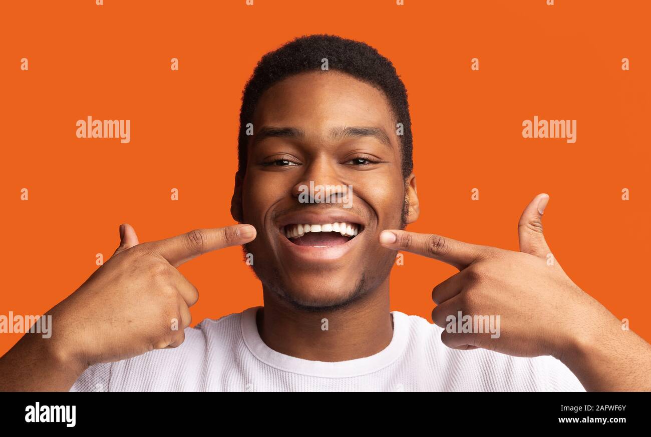 Black guy smiling and showing perfect healthy teeth Stock Photo Alamy