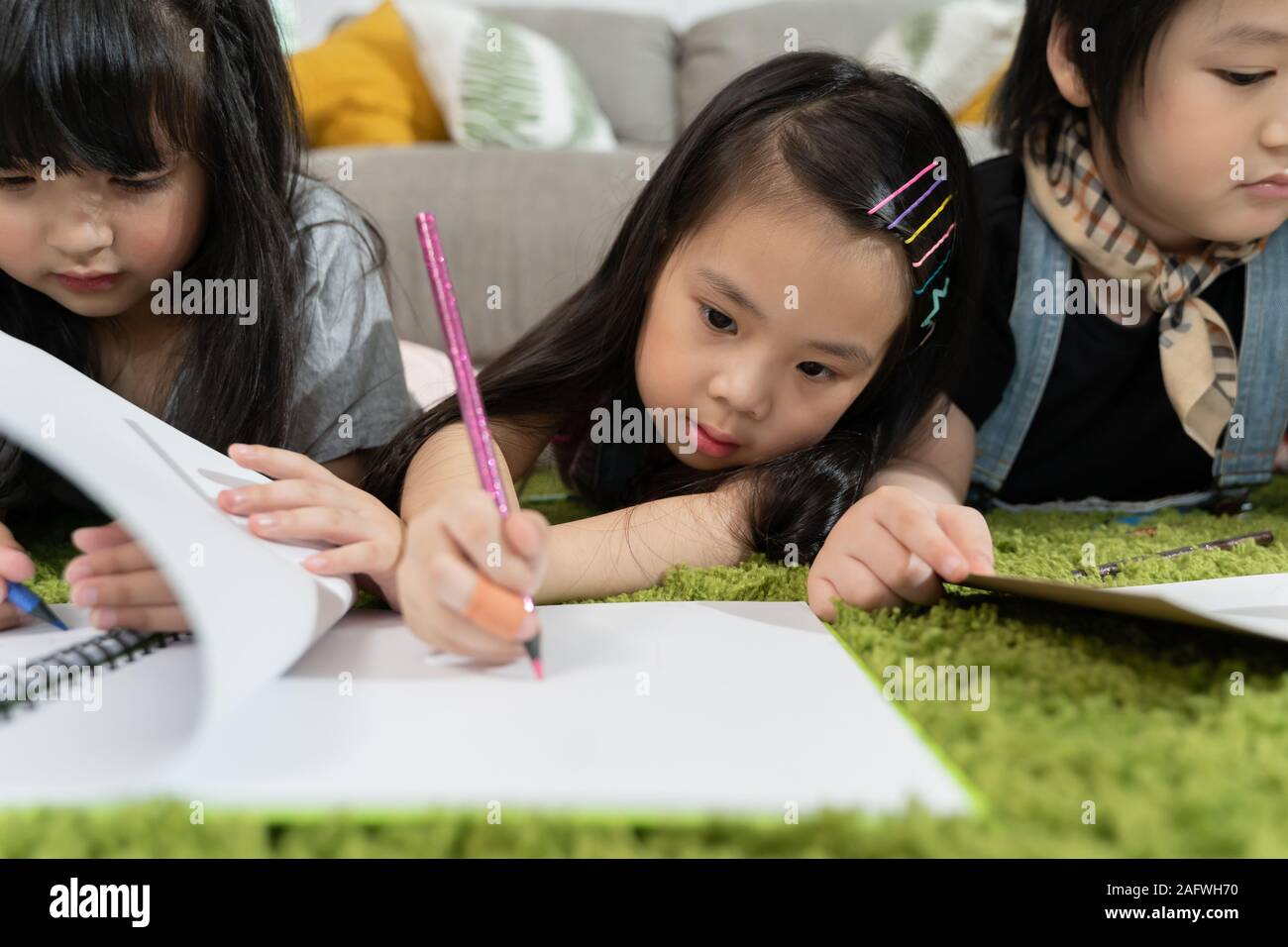 Group of little preschool kids drawing paper with color pencils ...