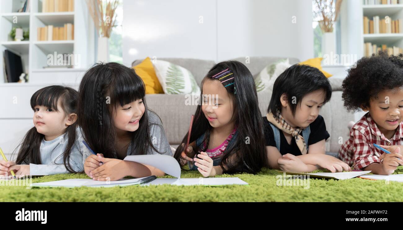 Group of little preschool kids drawing paper with color pencils ...