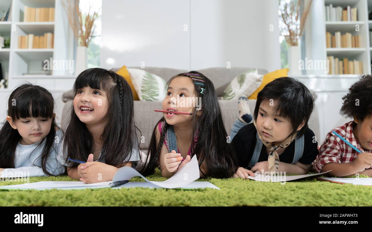 Group of little preschool kids drawing paper with color pencils ...
