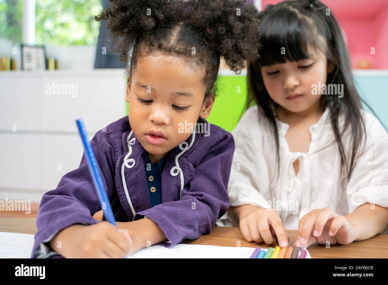 Group of little preschool kids drawing paper with color pencils ...