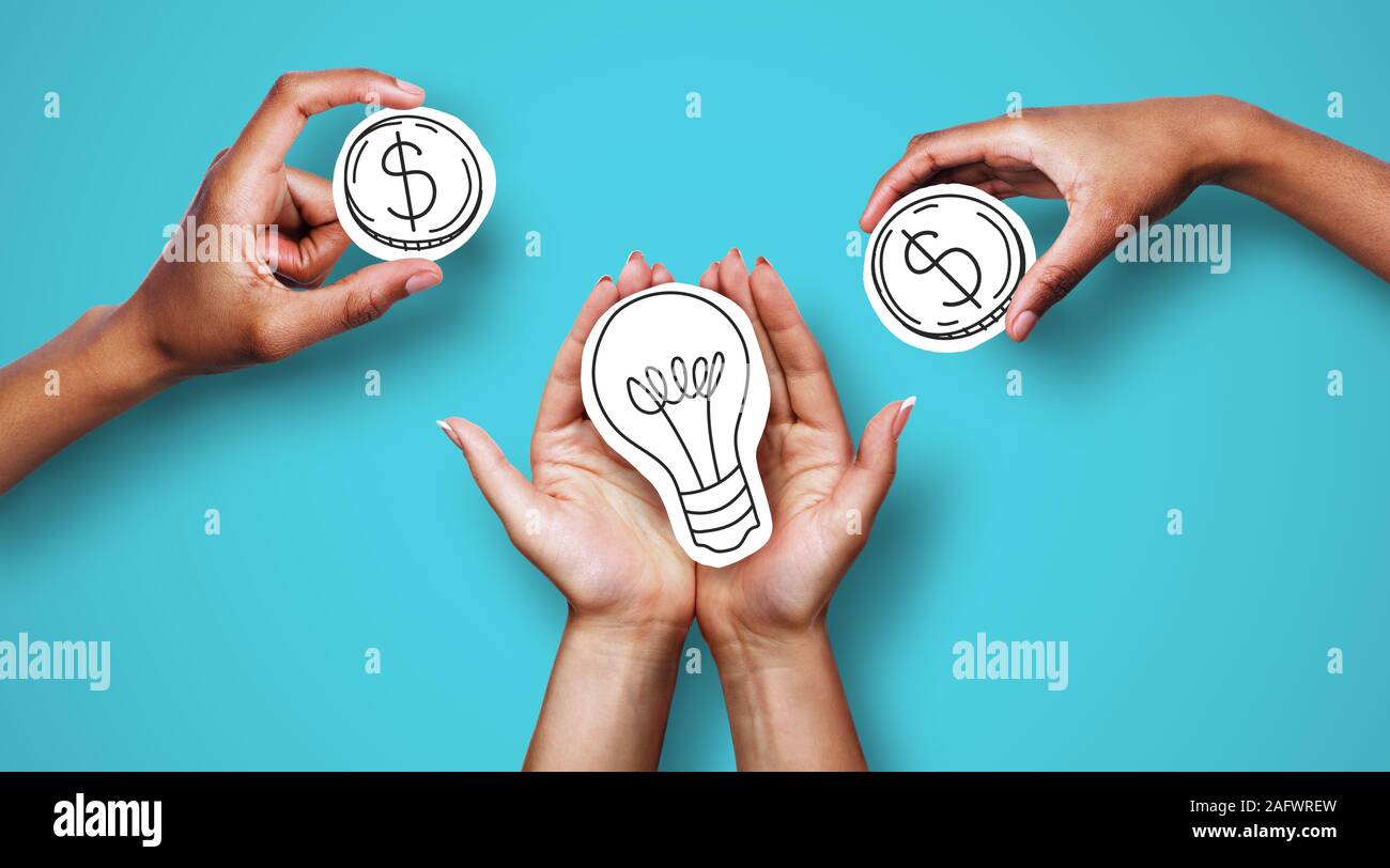 Hands with dollar sign coins and light bulb Stock Photo