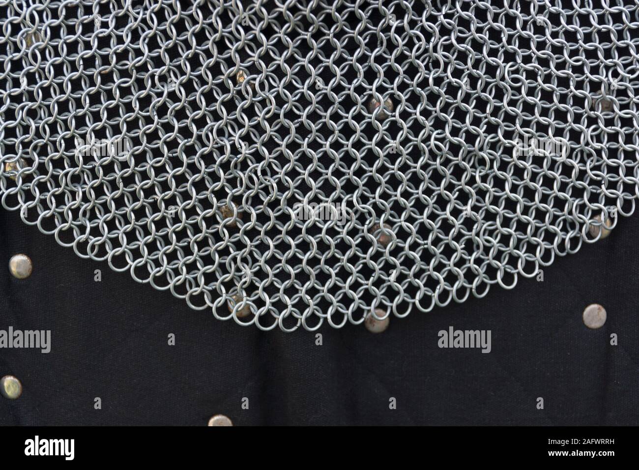 Medieval chainmail or mail coif or neck guard and a gambeson or padded