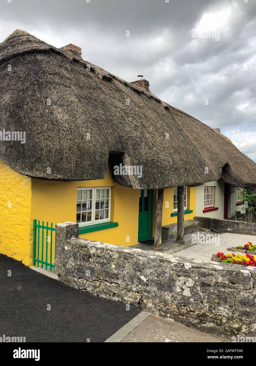 Adare, Ireland - 13 July,2018: Typical old cottage in Adare. Adare is a small village in County Limerick, Ireland. Architectural forms include the tha Stock Photo