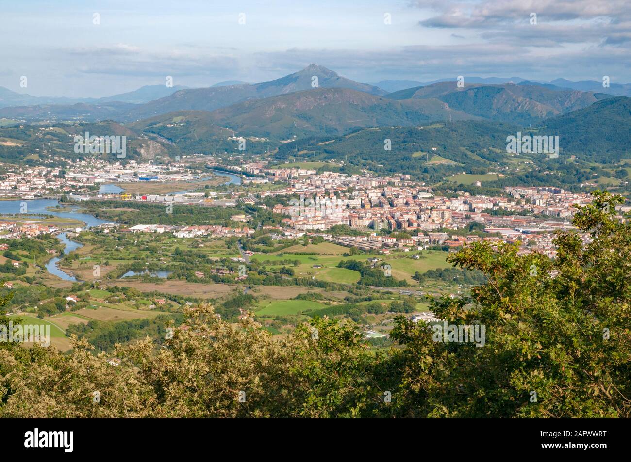 Views across Spain and France with Irun and Hendaye towns, hills and La Rhune mountain (France) from the viewpoint of Santa Barbara Dorrea, Spain Stock Photo